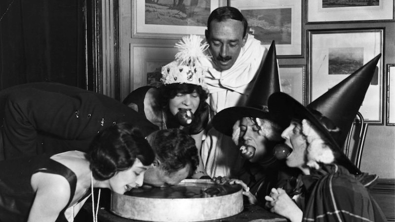 October 1922: An apple bobbing game at a Halloween fancy-dress party. Image: Topical Press Agency/Getty Images